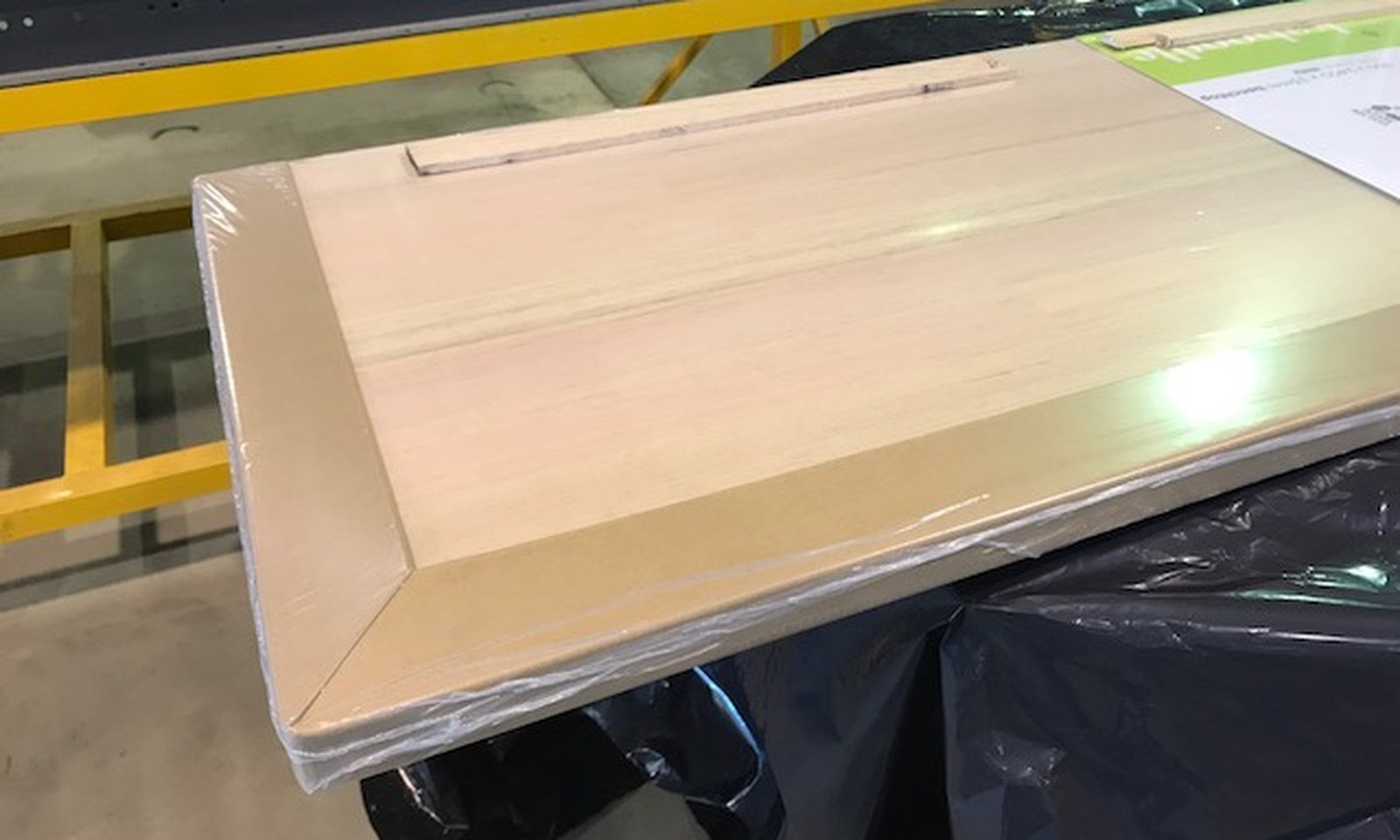 Finished panel protected with paper edge guards